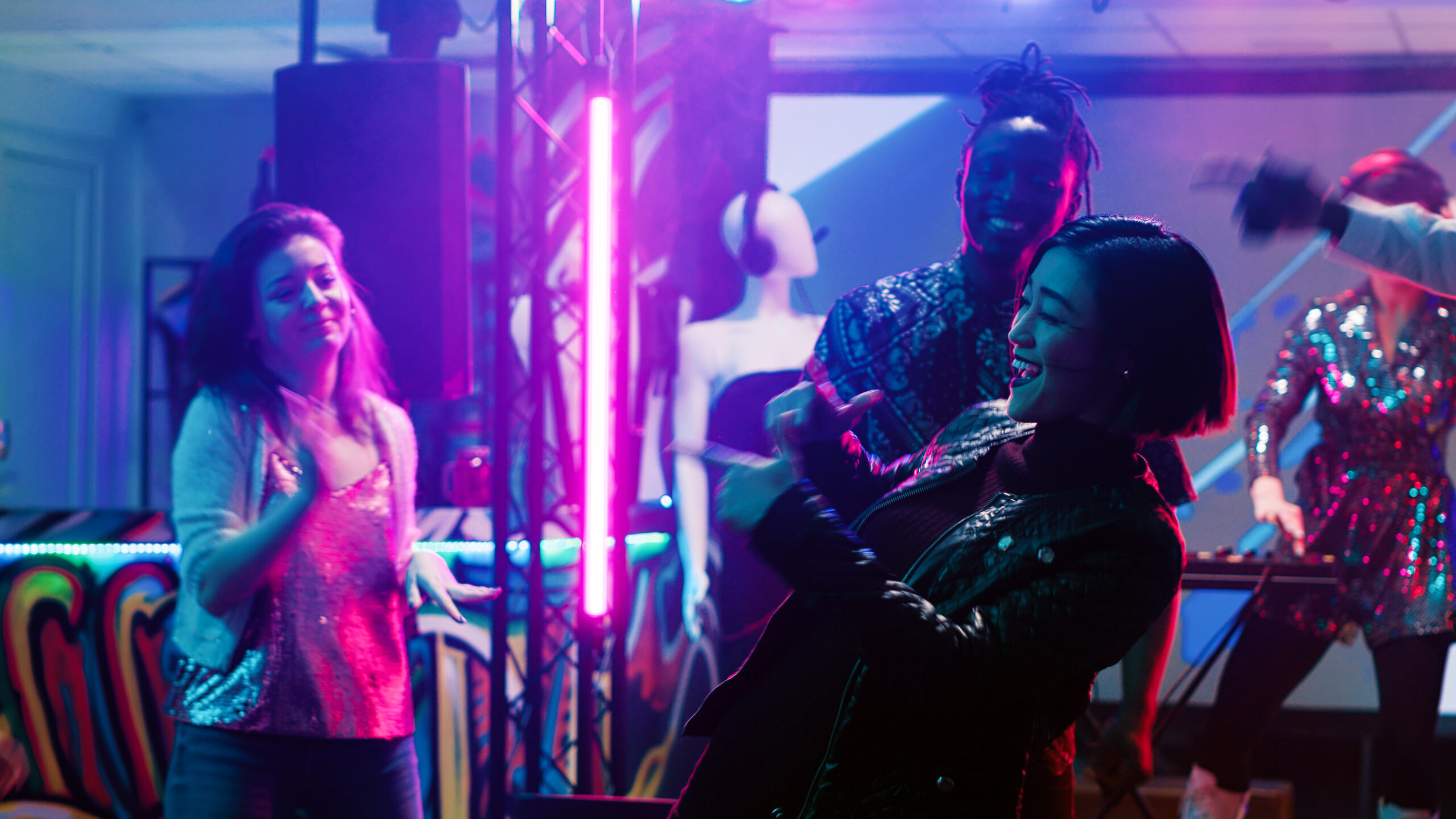 Asian girl dancing at the nightclub, feeling funky on dance floor and enjoying night out. Group of friends having fun in the club, partying under spotlights on disco music. Tripod shot.
